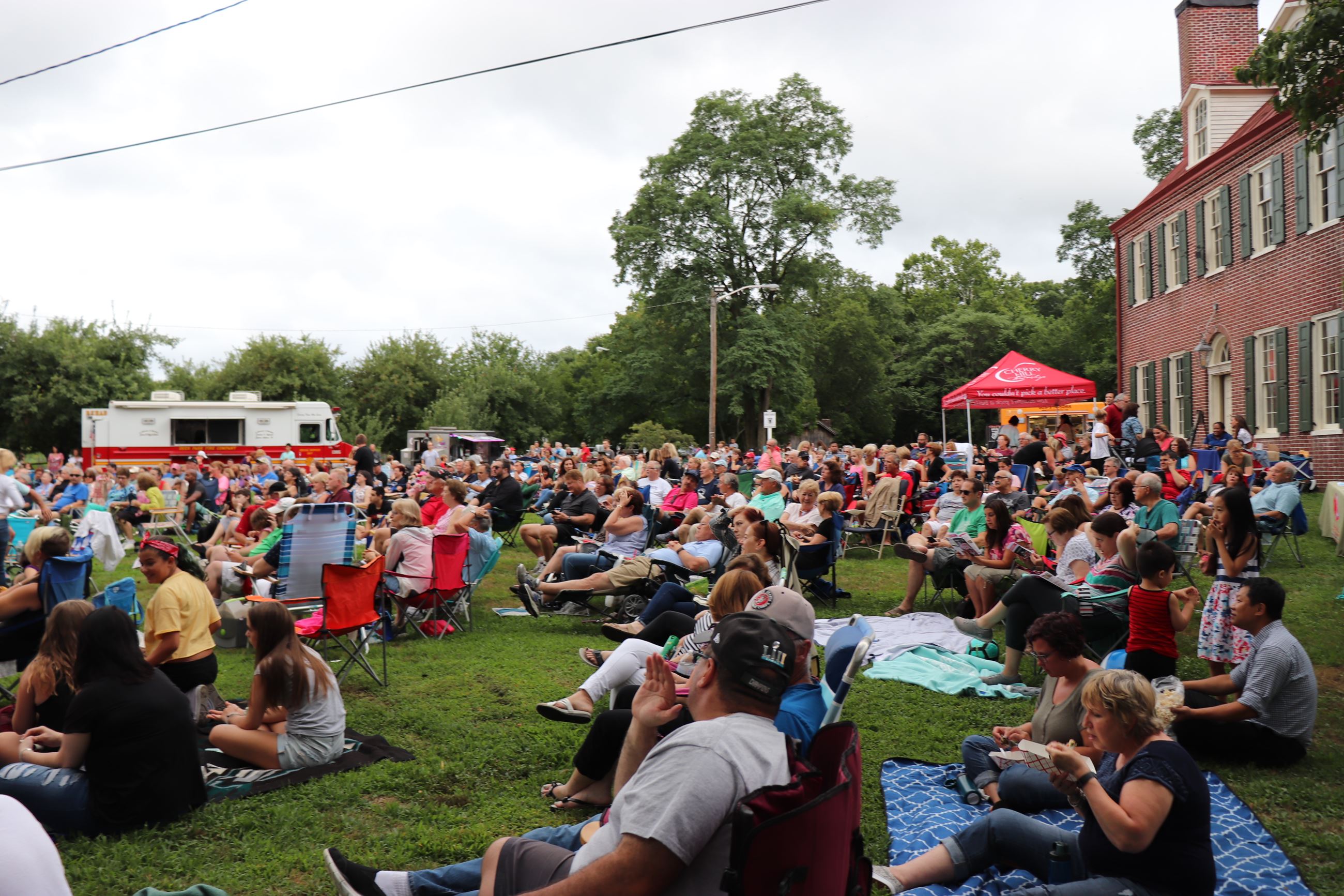 Crowd sitting on lawn